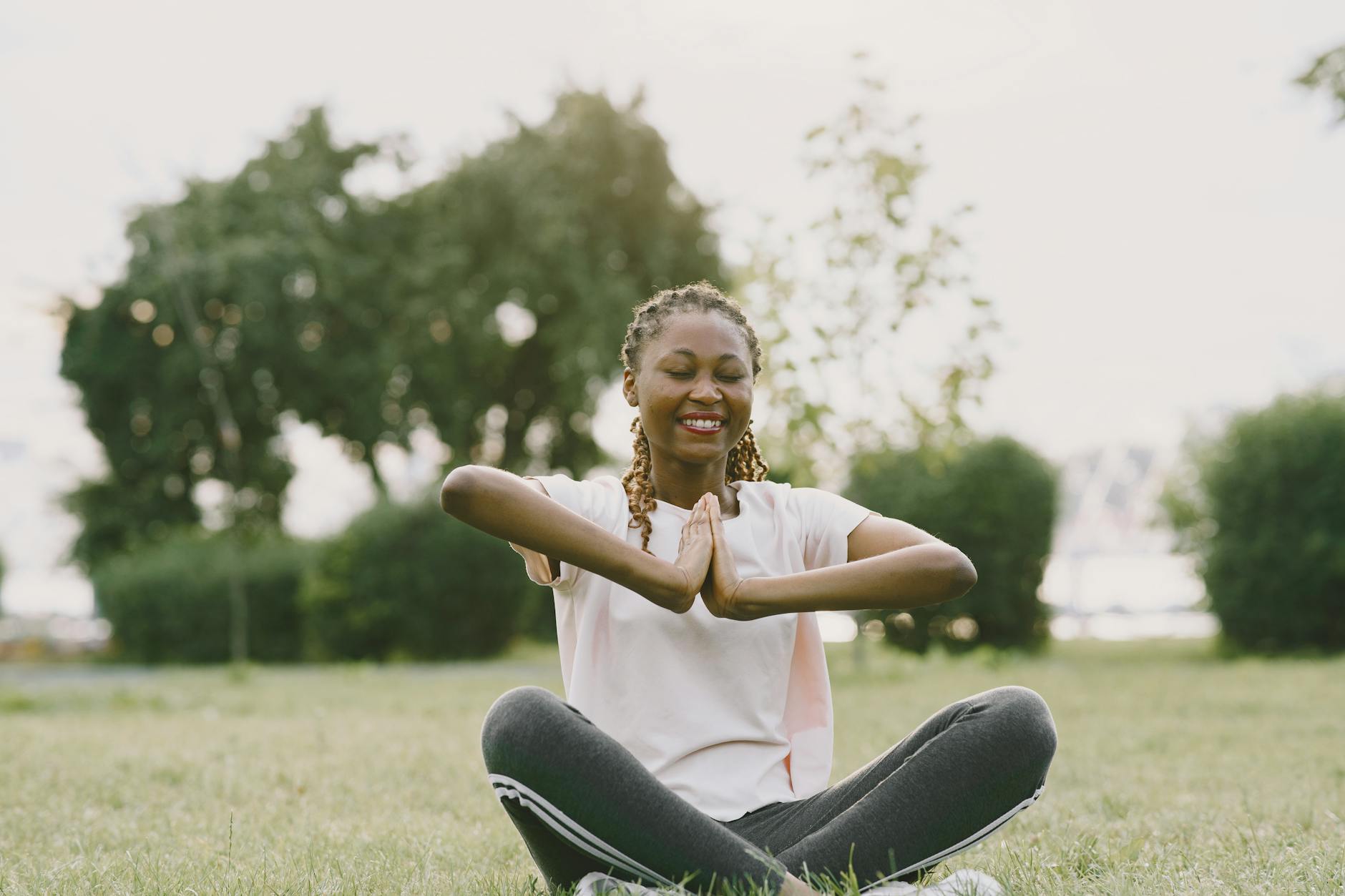 Person sitting peacefully by a lake, representing emotional balance and regulation